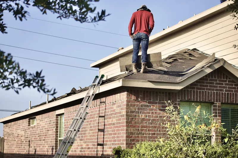 Professional roofer working on a residential roof in Keystone Park Colony
